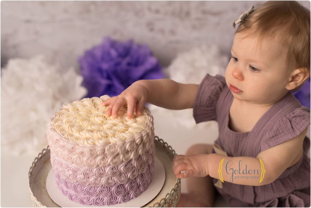 1 year old smashing cake for photos
