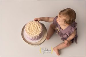 1 year old touching cake for one year photos