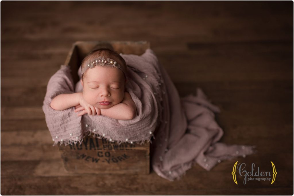 baby girl in antique crate