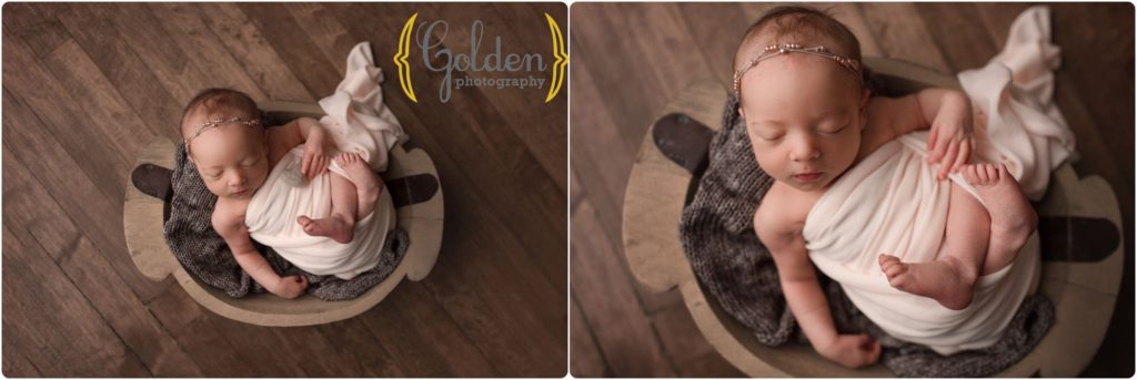 baby girl wrapped in photo studio bowl