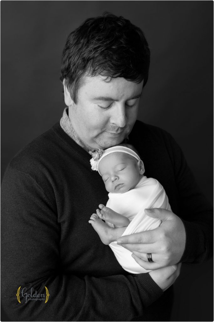 dad holding newborn baby