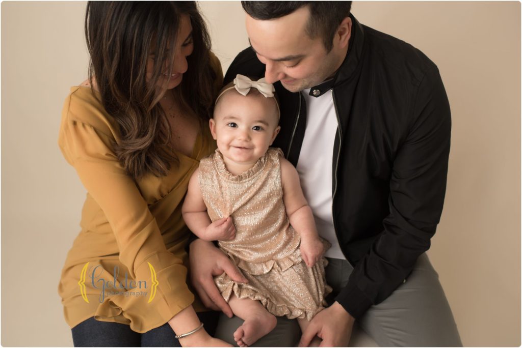 family of 3 sitting in Lake County photo studio