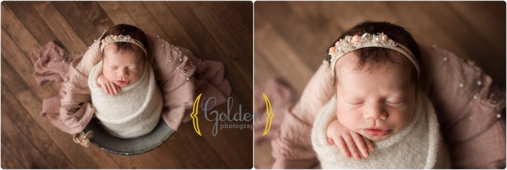 newborn girl wrapped in white