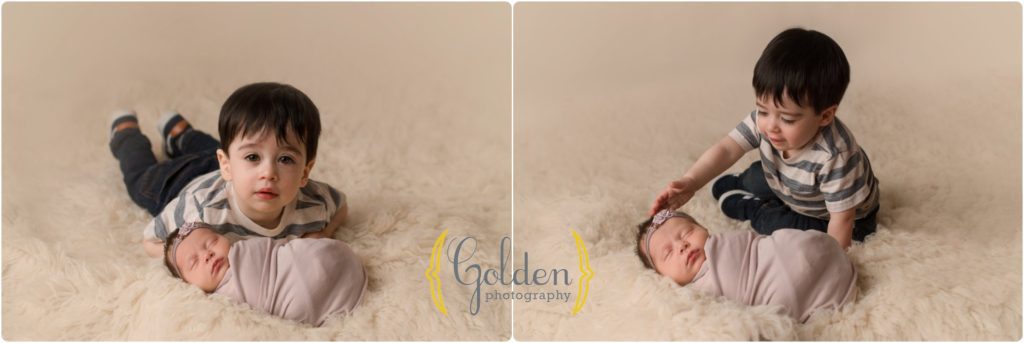 brother holding newborn baby sister