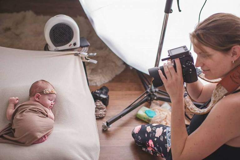 Stacy Golden photographing a newborn in her Lake Zurich photo studio
