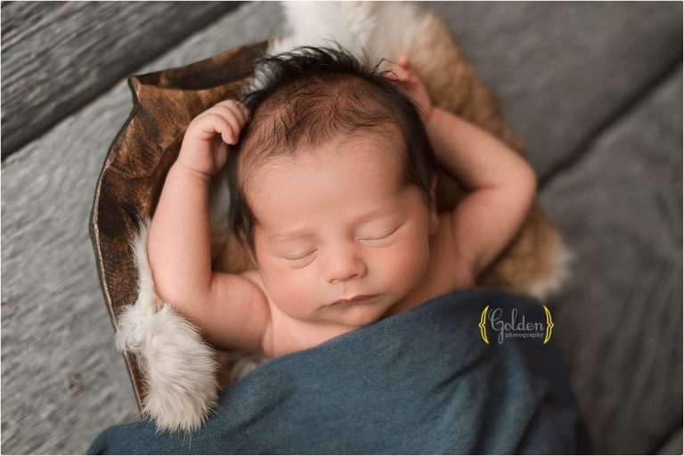 baby brother sleeping with arms up with best newborn photographer in Chicago