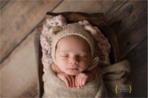 newborn baby asleep with animal bonnet in Lake County IL