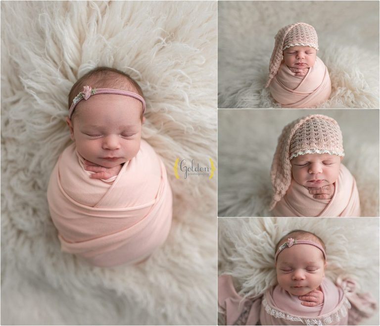 baby girl wrapped in pink for baby photos on white rug