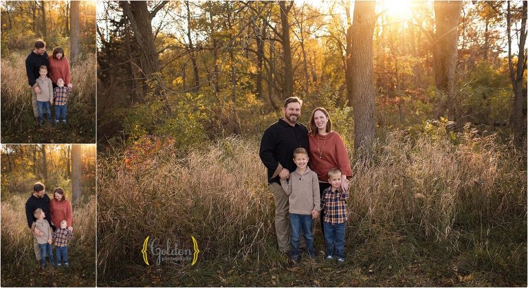 family posing for photos in a field at sunset