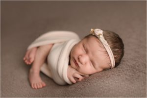 baby girl wrapped in cloth for best newborn photos
