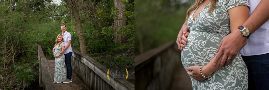 hands holding pregnant belly on a bridge