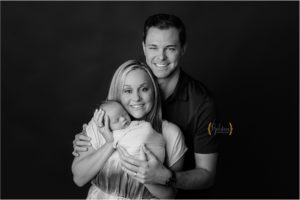 black and white of new family holding baby boy