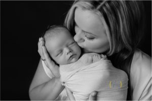 mom kissing baby boy during photo session