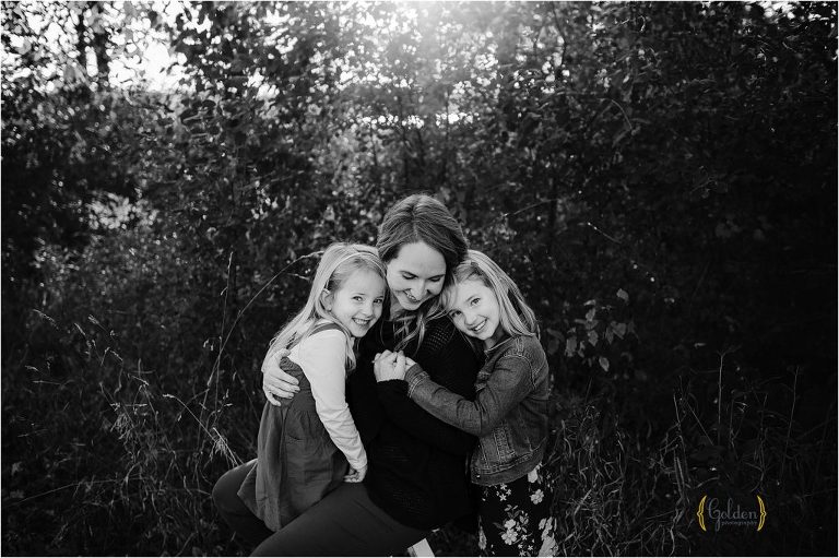 black and white of mom with two young daughters