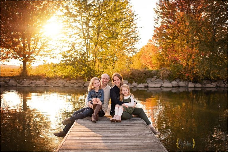 family posing on a dock for fall family photos in Lake Barrington IL
