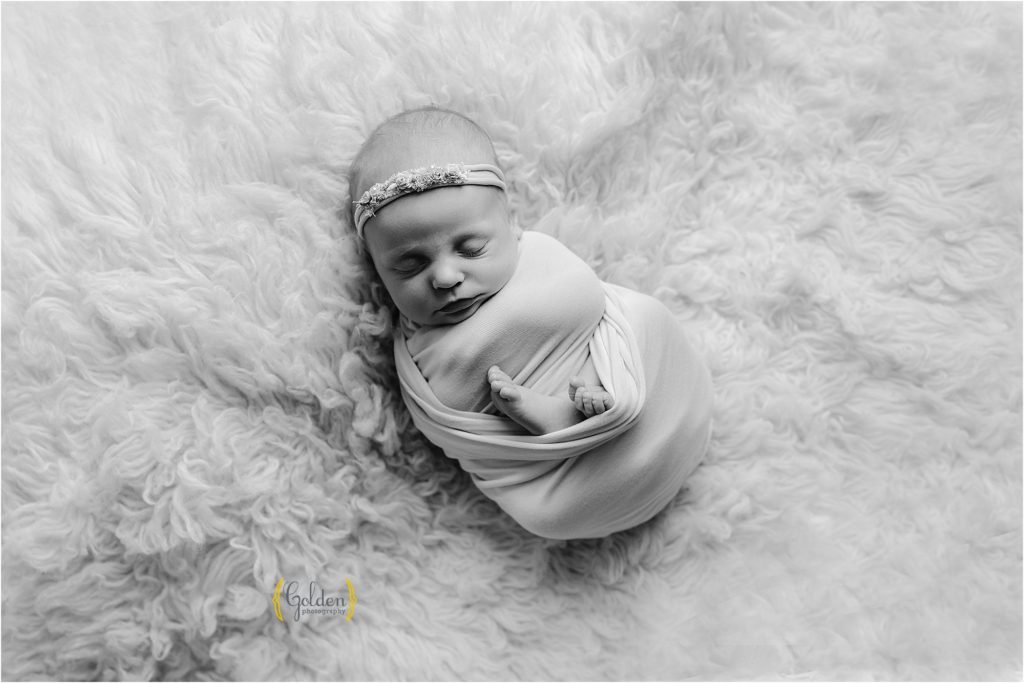 newborn posed on shaggy rug for photo session with Libertyville IL photographer