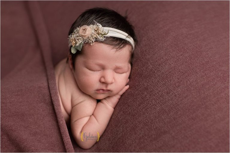 newborn baby wearing headband for newborn photo session near Crystal Lake