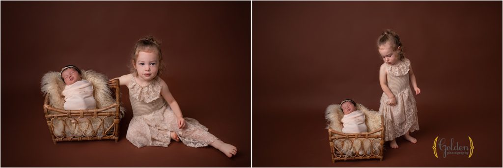 girl posing with baby sister during newborn photography near Crystal Lake IL