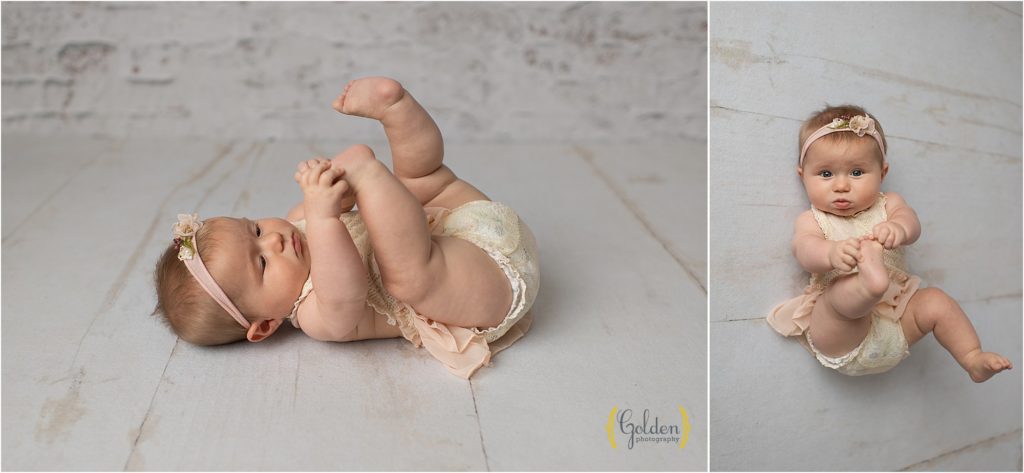 6 month old baby touches toes in photography studio near Hawthorn Woods IL