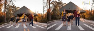family posed in front of Long Grove covered bridge for photo session
