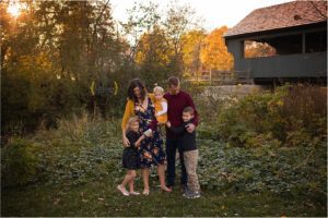 family hugging near Long Grove, IL covered bridge