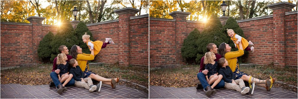 family sitting on the ground in Long Grove courtyard