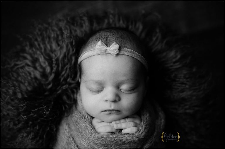 black and white of sleeping baby on furry ruh