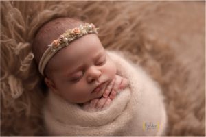 swaddled newborn asleep in Arlington Heightsphotography studio