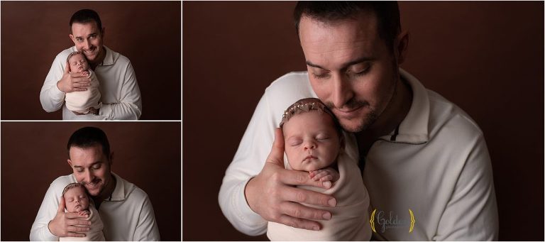 dad holding swaddled newborn baby girl