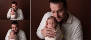 dad holding swaddled newborn baby girl