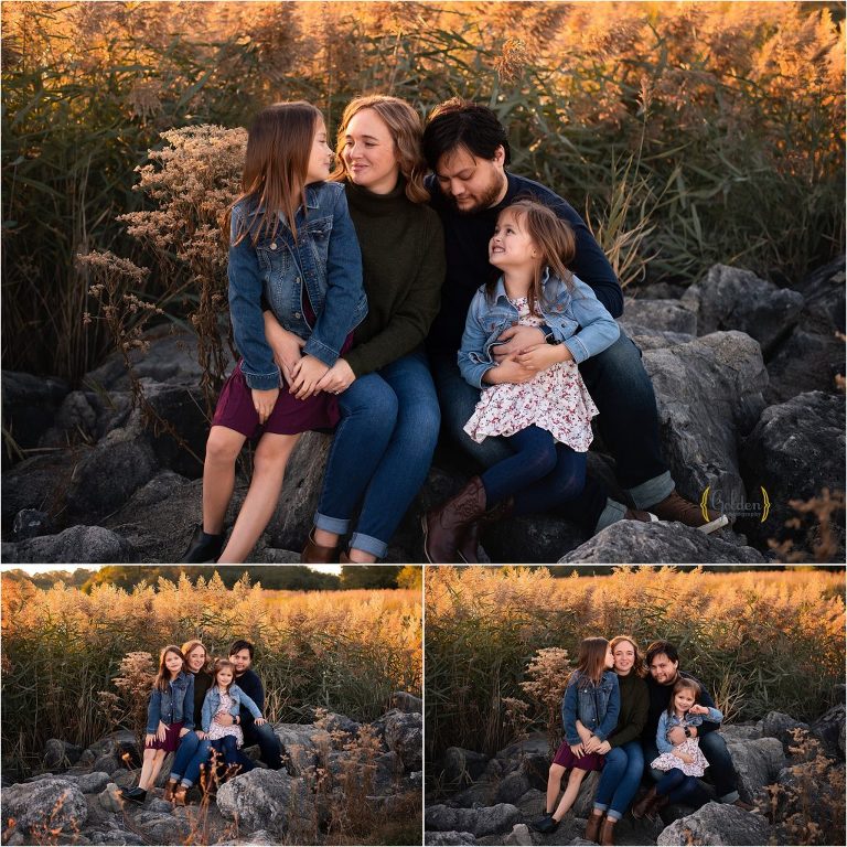 family sitting on rock for family photography in Schaumburg IL forest preserve