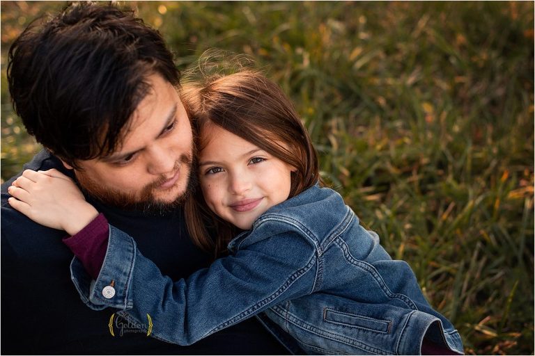 girl hugging dad for family photos