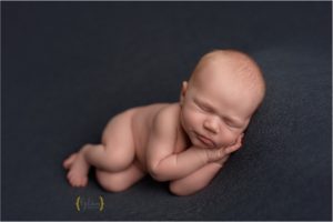 baby boy asleep on blue fabric in Palatine IL studio