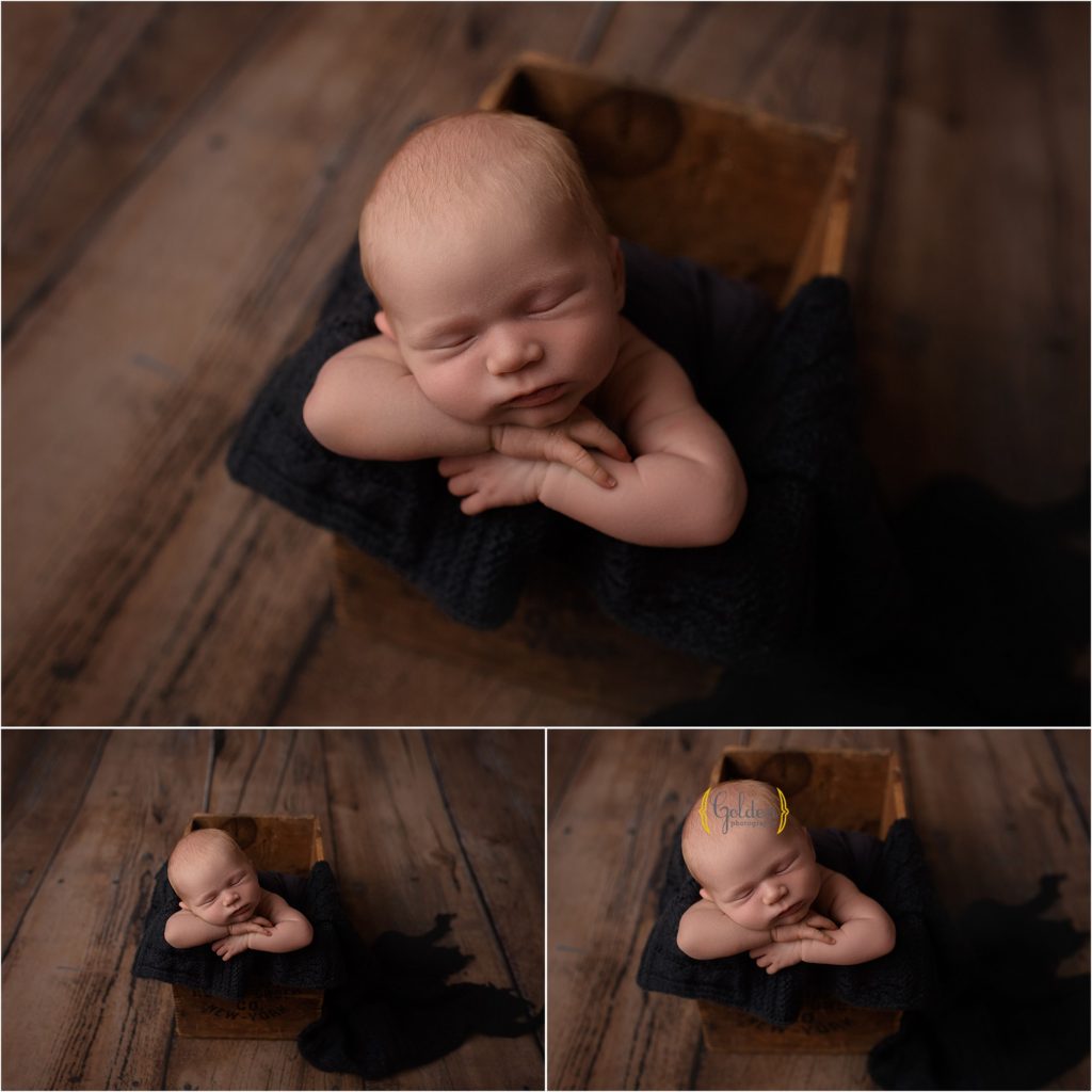 sleeping newborn posed in a wooden crate in Lake Zurich studio