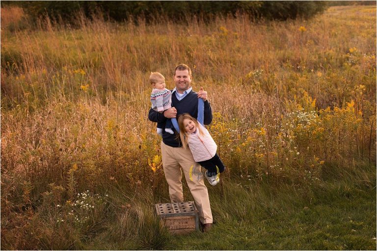 dad playing with daughters during family photo session in Long Grove IL
