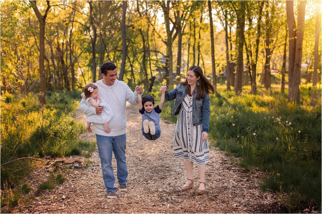 family walking and swinging child near Barrington IL