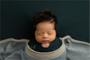 newborn wrapped in blue for newborn photos