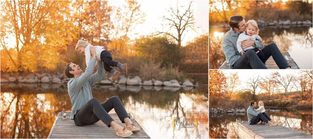 dad sitting with son on a dock for family photos