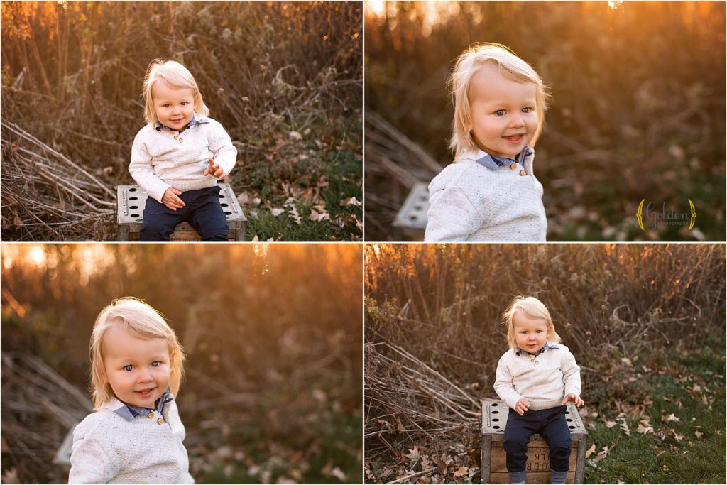 boy sitting on a crate and smiling