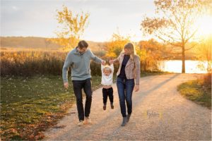 family walking on a path and swinging son in Barrington IL