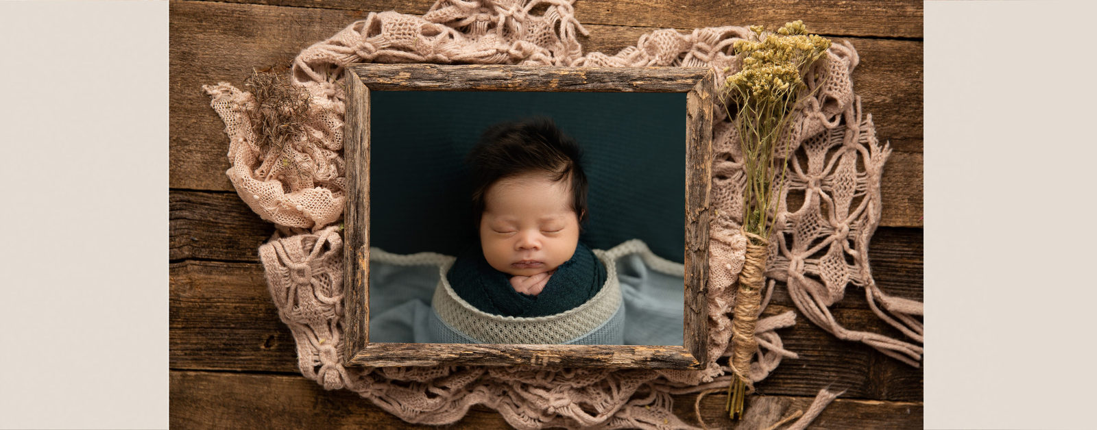 framed print of newborn baby in barnwood frame